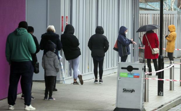 Bracknell News: People queue at The Centre in Slough, Berkshire, after a rapid testing hub was opened for local residents during England's third national lockdown to curb the spread of coronavirus. PA Photo. Picture date: Wednesday January 13, 2021. Under increased meas