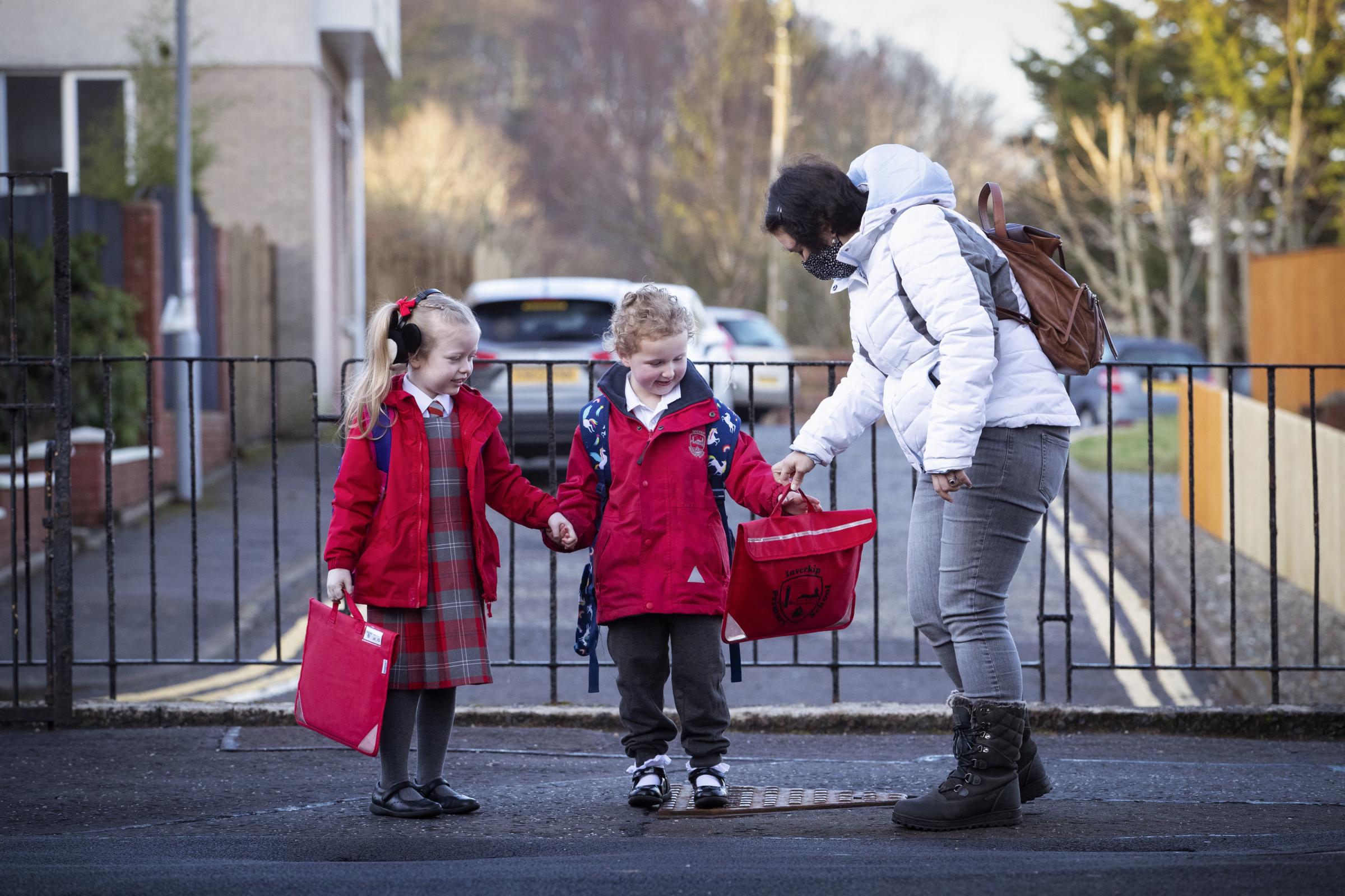 P1 pupils Grace Lee (left) and classmate Grace McKeeman, both aged 5, arrive for their first day back at Inverkip Primary School in Greenock as Scotlands youngest pupils return to the classroom as part of a phased reopening of schools. Picture date: Mon