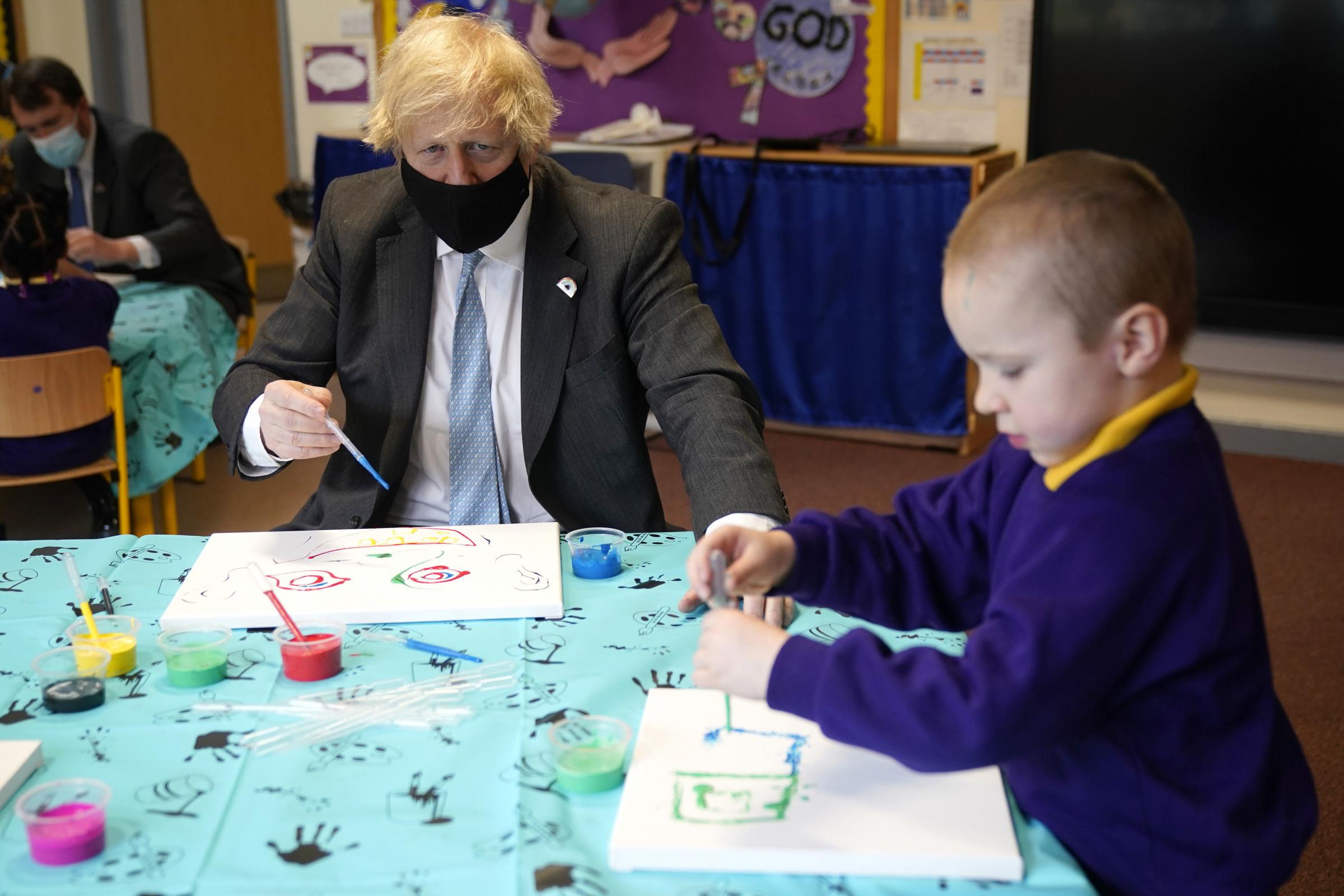 Prime Minister Boris Johnson joins a reception class painting lesson during a visit to St Marys CE Primary School in Stoke-on-Trent, Staffordshire, to see how they are preparing for students to return. Picture date: Monday March 1, 2021. PA Photo. See