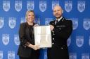 Detective Constable Zoe Eele with her award from Chief Constable Jason Hogg
