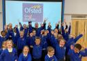 Headteacher Richard Ferris celebrates the \'Good\' OFSTED rating with pupils at Great Hollands Primary School in Bracknell. Credit: Maiden Erlegh Trust