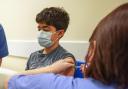Xavier Aquilina, aged 11, has a Covid-19 vaccination at the Emberbrook Community Centre for Health, in Thames Ditton, Surrey. Photo via PA.