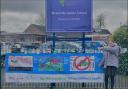 School children display their ‘anti-idling’ banners to help reduce pollution