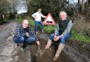 Kevin Harlock (left), Caroline Wilkie (center) and Ronnie Wilkie (right) feel they are cut off from the rest of the world because of potholes near their homes