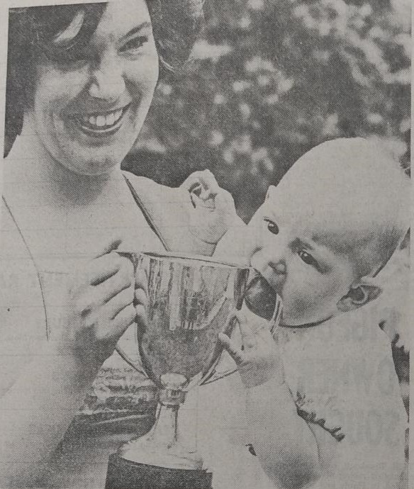 Baby Suzanne Potter nibbles on the trophy after her win 