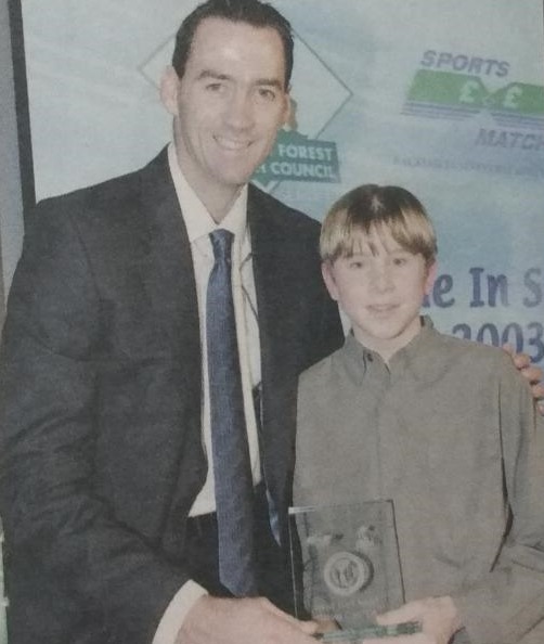 James Coombe win an award for his biathlon performances. He is pictured next to Martin Bicknell