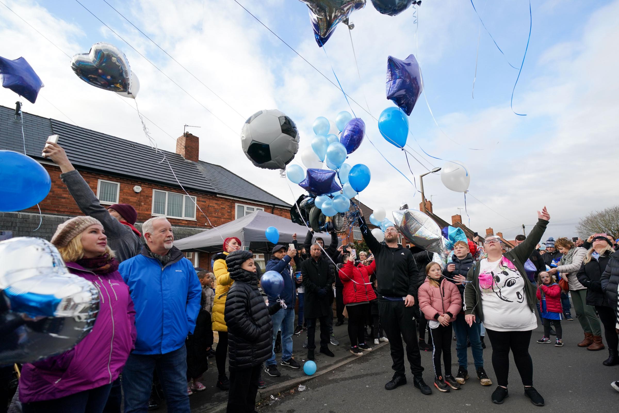 People release balloons during a tribute to six-year-old Arthur Labinjo-Hughes outside Emma Tustins former address in Solihull, West Midlands, where he was murdered by his stepmother on December 5 (PA)