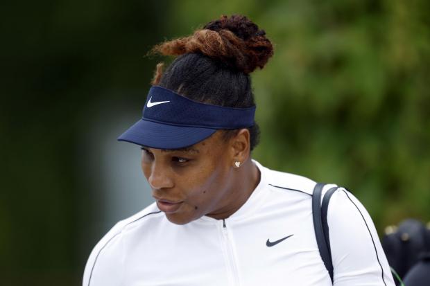 Serena Williams walks to the practice courts