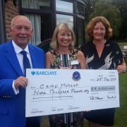 East Berks captains Peter Stevens and Donna Hunt present a cheque to Camp Mohawk's Annabel Hill