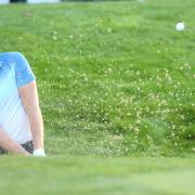 Danny Willett of England plays out of the bunker on the 18th hole during the BMW PGA Championship Day 3