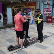 A youngster on an e-scooter is quizzed by police in Bracknell town centre
