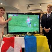 Sarah and Anna watching England’s win against Ukraine at their wedding