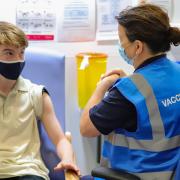 A14 year-old receives his first dose of the Covid-19 vaccine