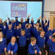 Headteacher Richard Ferris celebrates the \'Good\' OFSTED rating with pupils at Great Hollands Primary School in Bracknell. Credit: Maiden Erlegh Trust