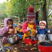 Children enjoying a class in the 'mud kitchen'