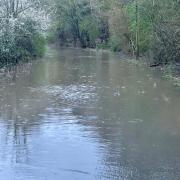 Flood warning announced at Emm Brook as roads become impassable.