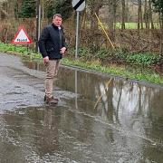 Wayne Smith inspects flooding on Blakes Lane, just off the A4 Bath Road