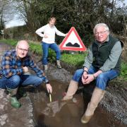 Kevin Harlock (left), Caroline Wilkie (center) and Ronnie Wilkie (right) feel they are cut off from the rest of the world because of potholes near their homes